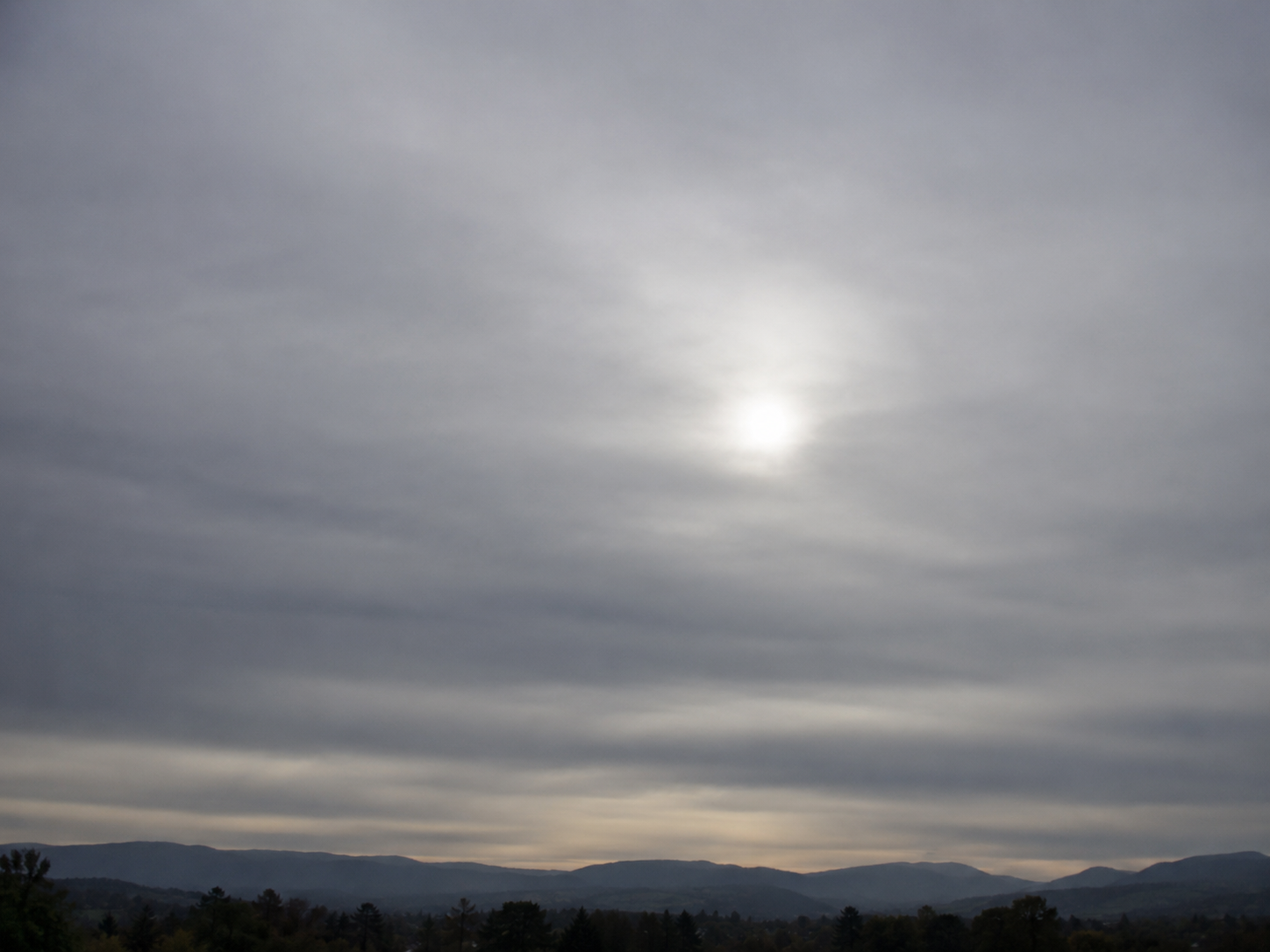 Altostratus clouds: A gray or blue-gray sheet that turns the sun into a dim, watery disc.