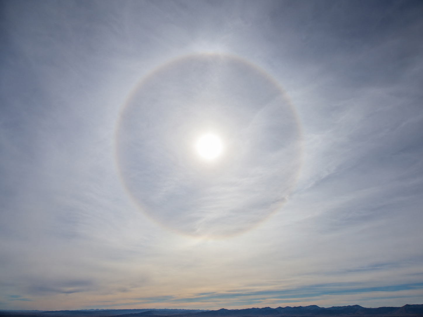 Cirrostratus clouds: A thin, milky veil across the entire sky. Often produces a halo around the sun or moon.