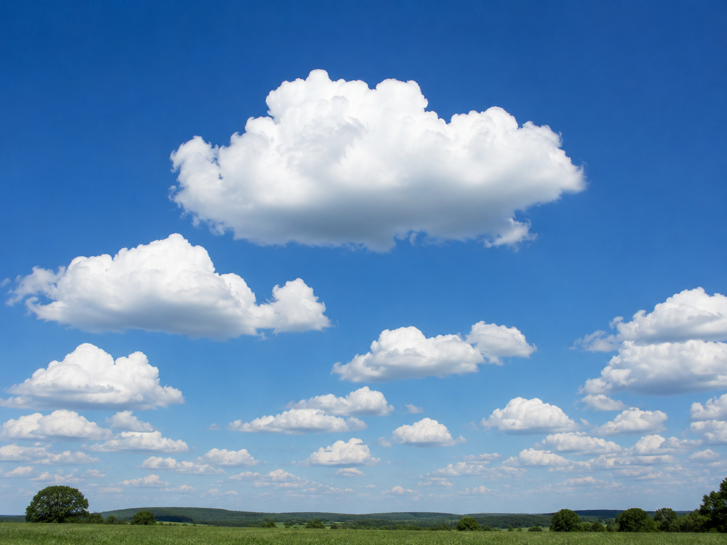 Cumulus clouds: Bright white, fluffy "cotton ball" clouds with crisp edges and flat bases.
